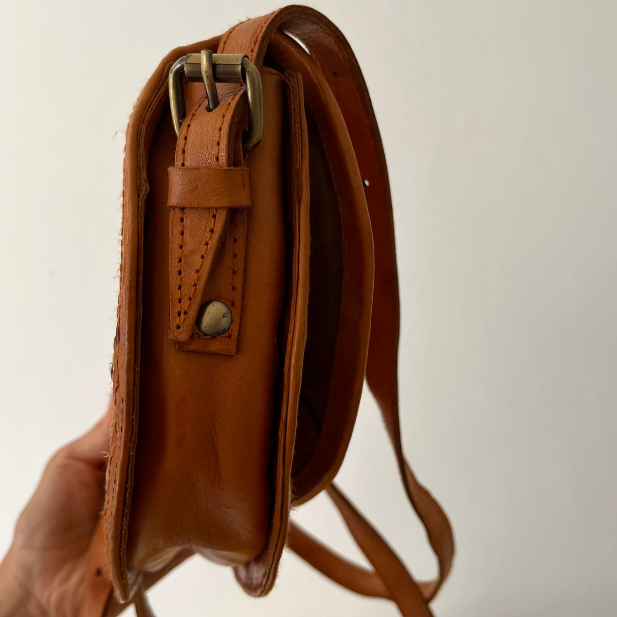 Tan leather half-moon crossbody bag