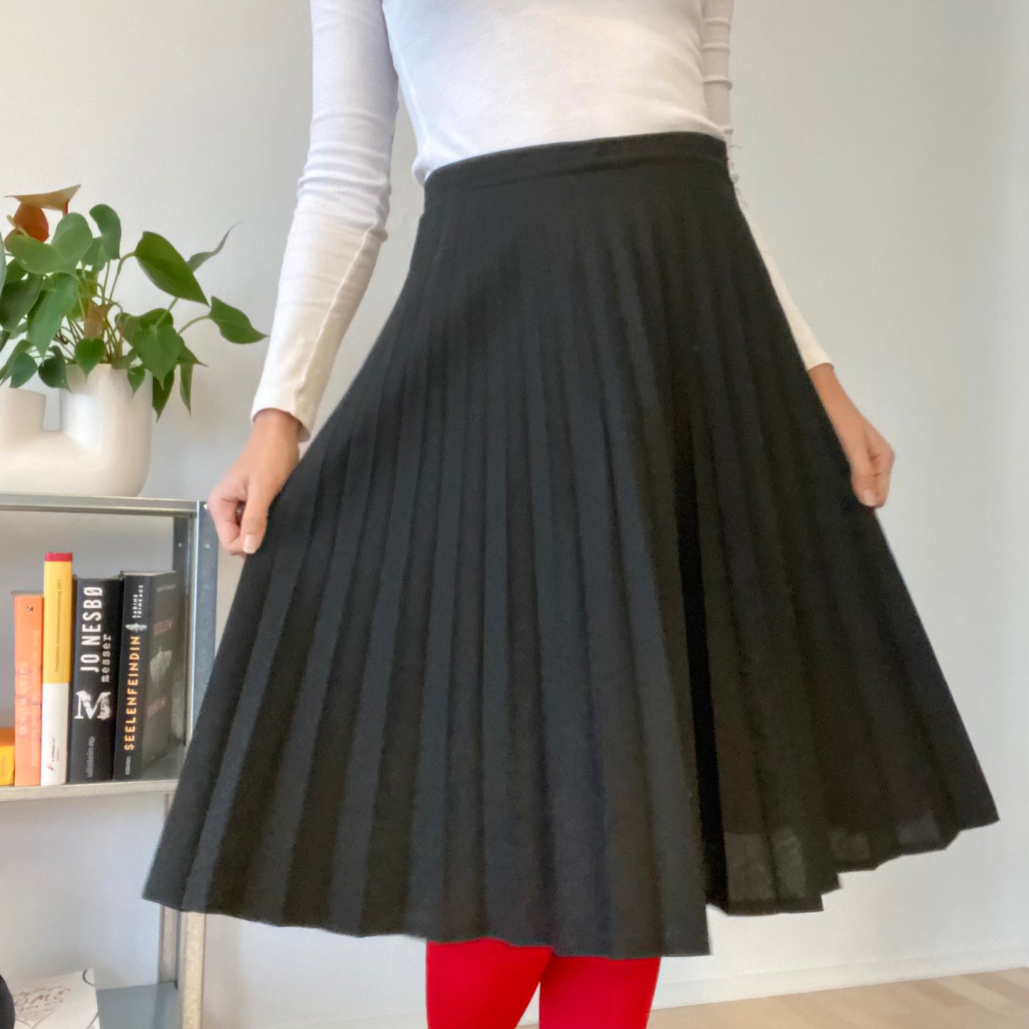 Knee length black pleaded skirt