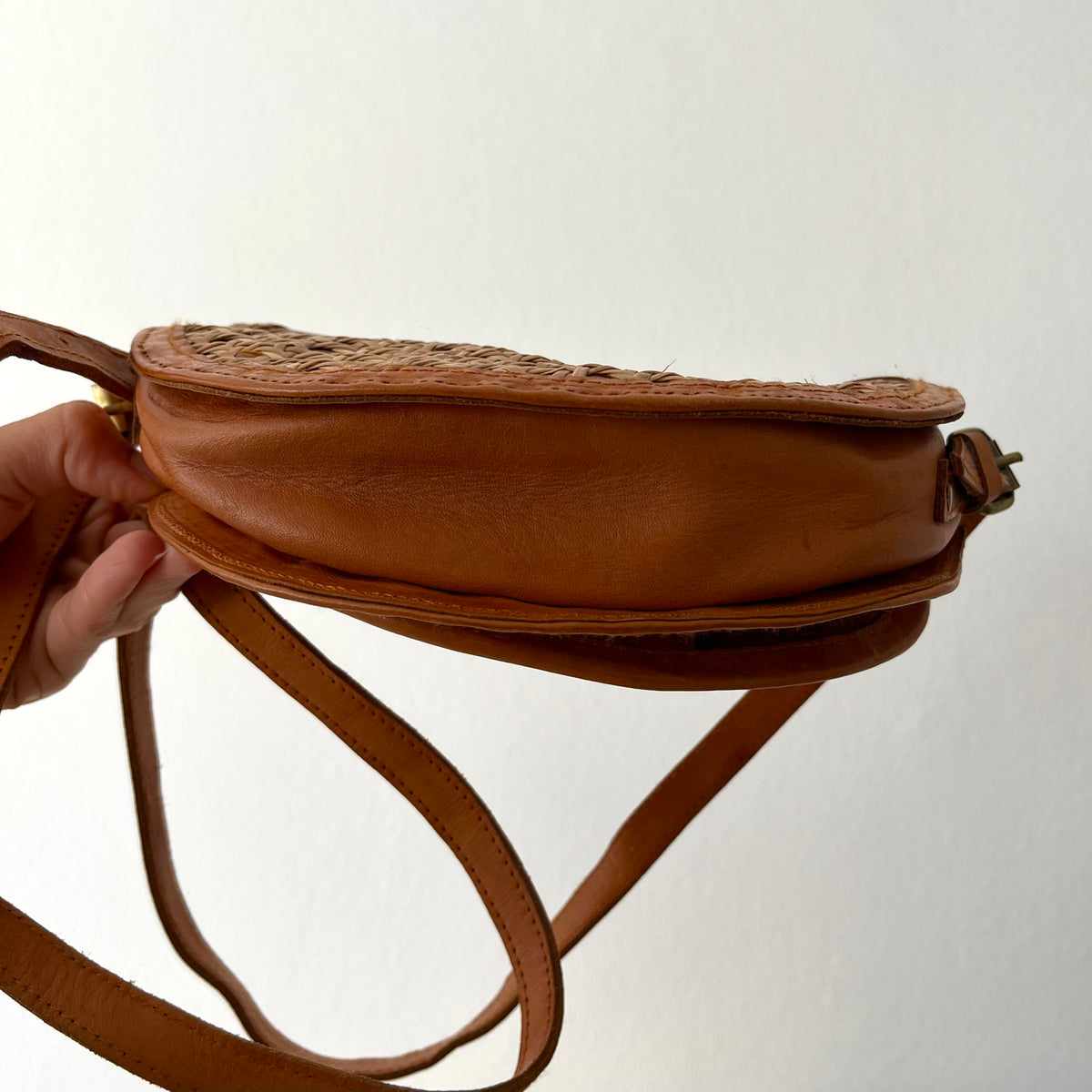 Tan leather half-moon crossbody bag