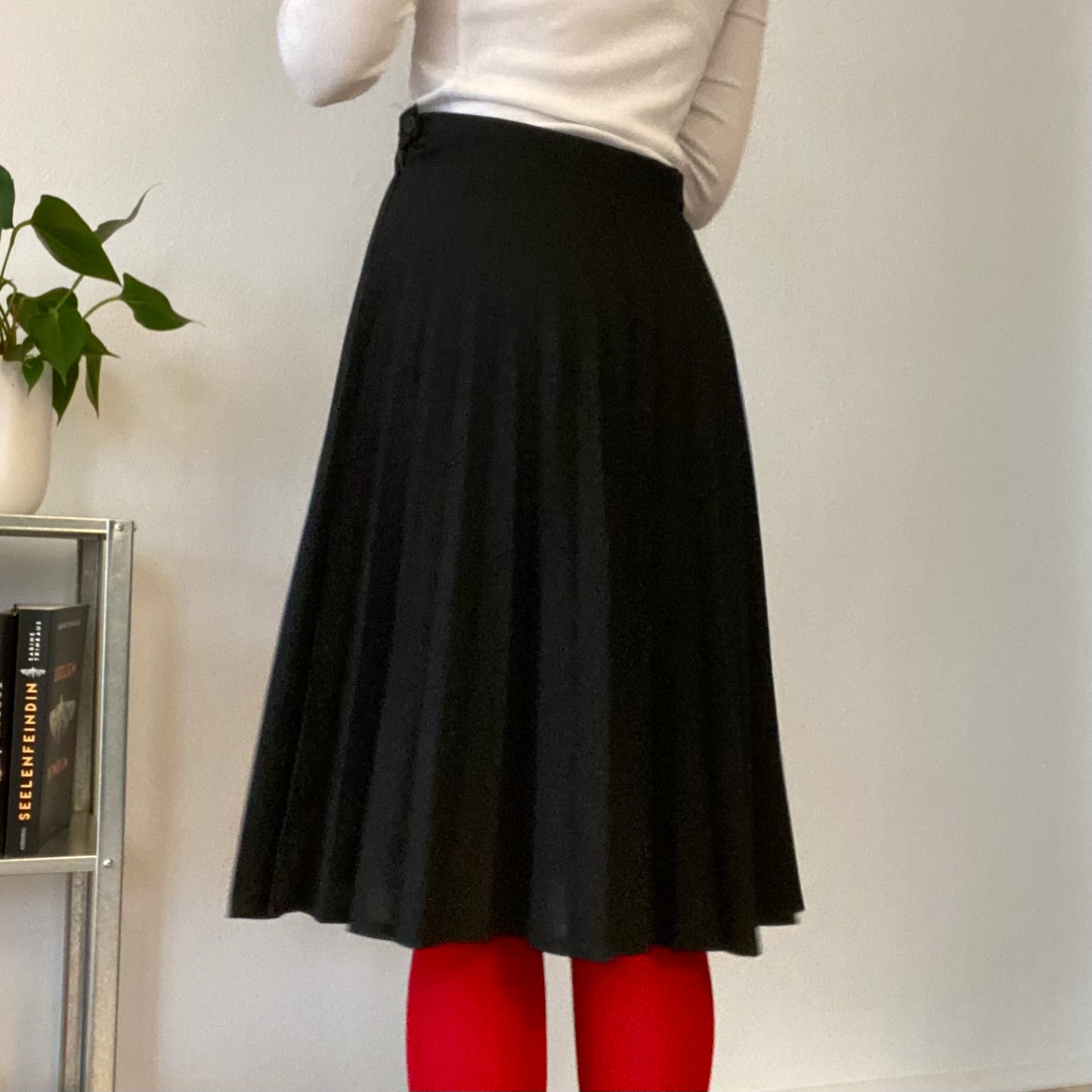 Knee length black pleaded skirt