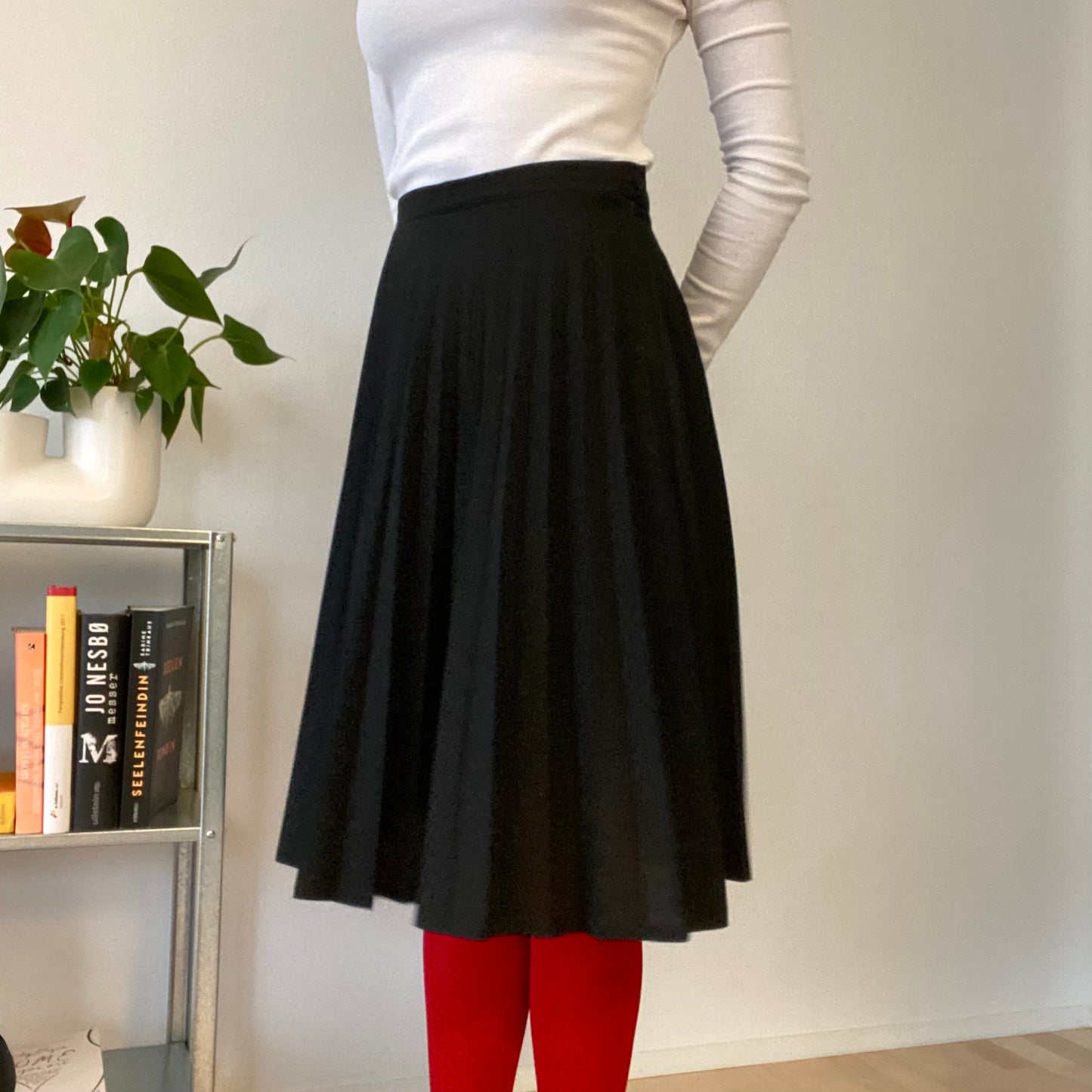 Knee length black pleaded skirt