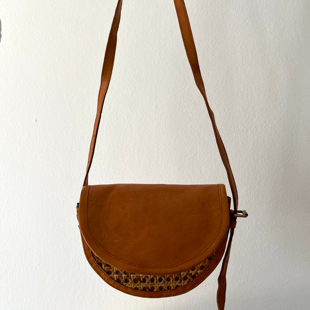 Tan leather half-moon crossbody bag