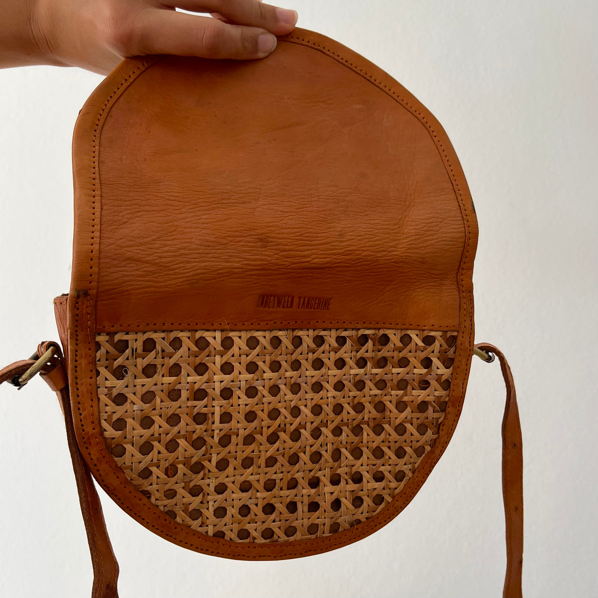 Tan leather half-moon crossbody bag