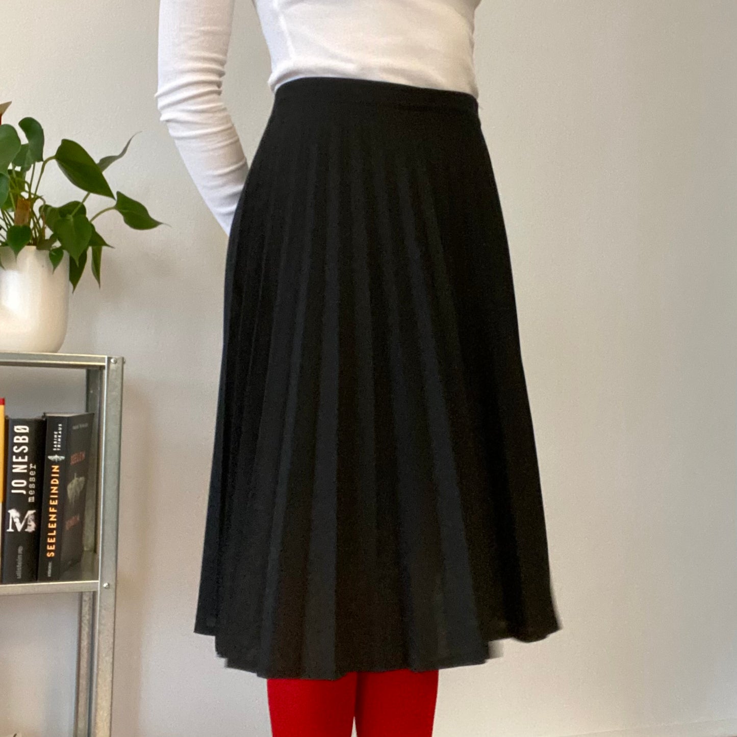 Knee length black pleaded skirt