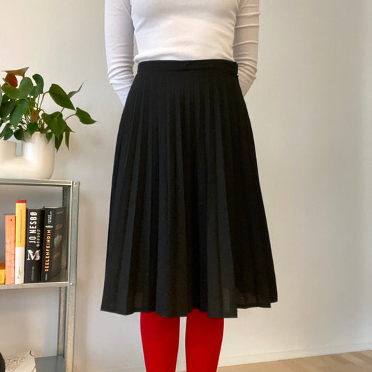Knee length black pleaded skirt