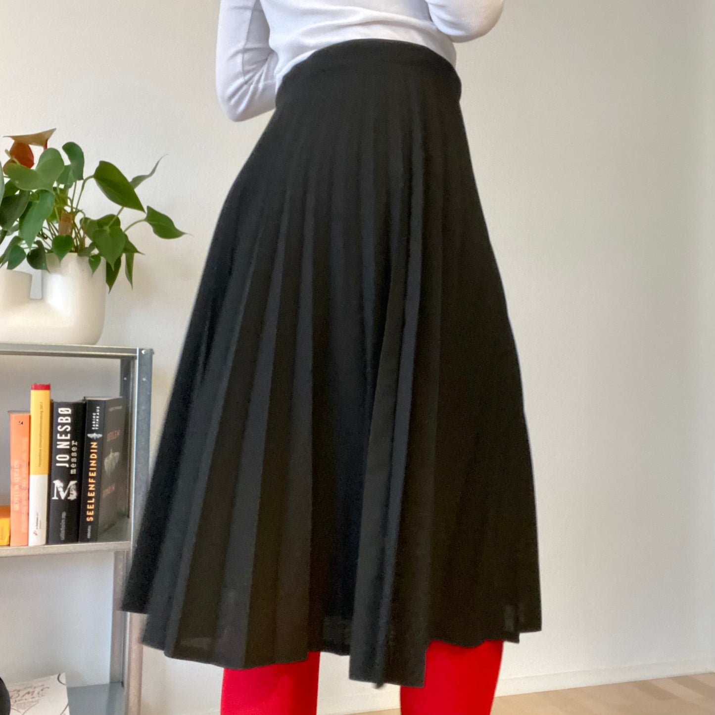 Knee length black pleaded skirt