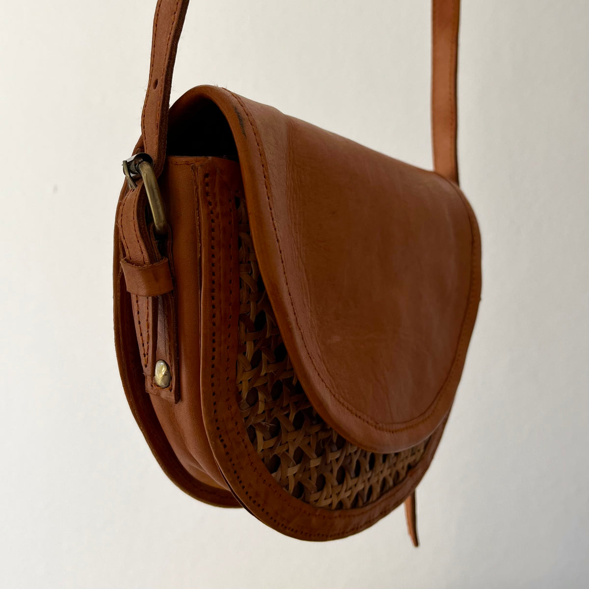 Tan leather half-moon crossbody bag