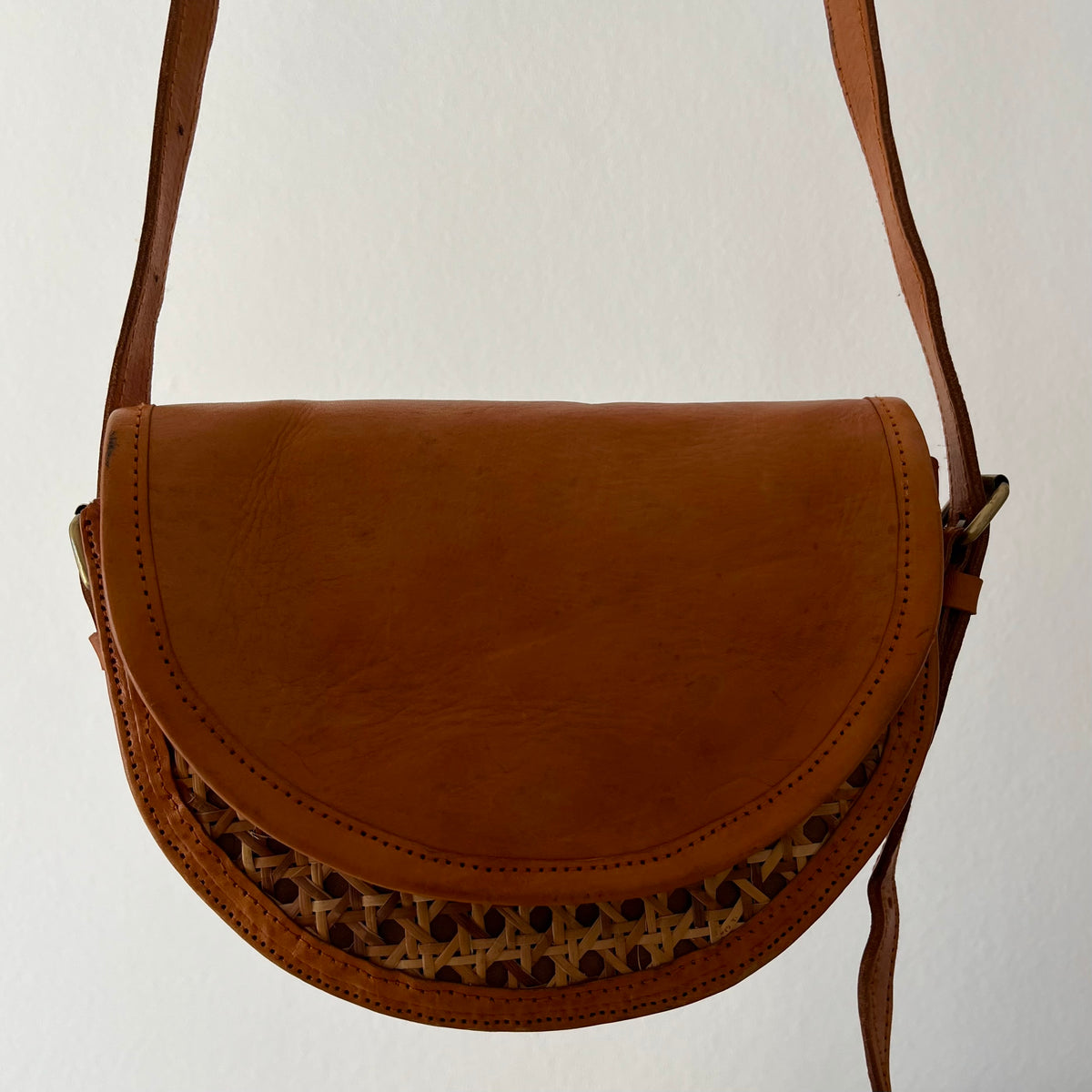 Tan leather half-moon crossbody bag