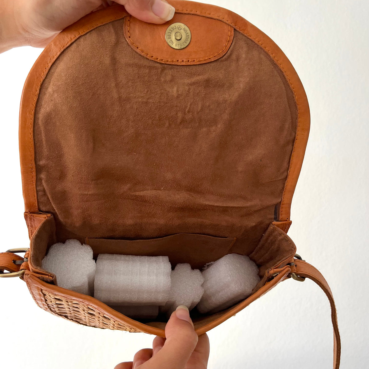 Tan leather half-moon crossbody bag