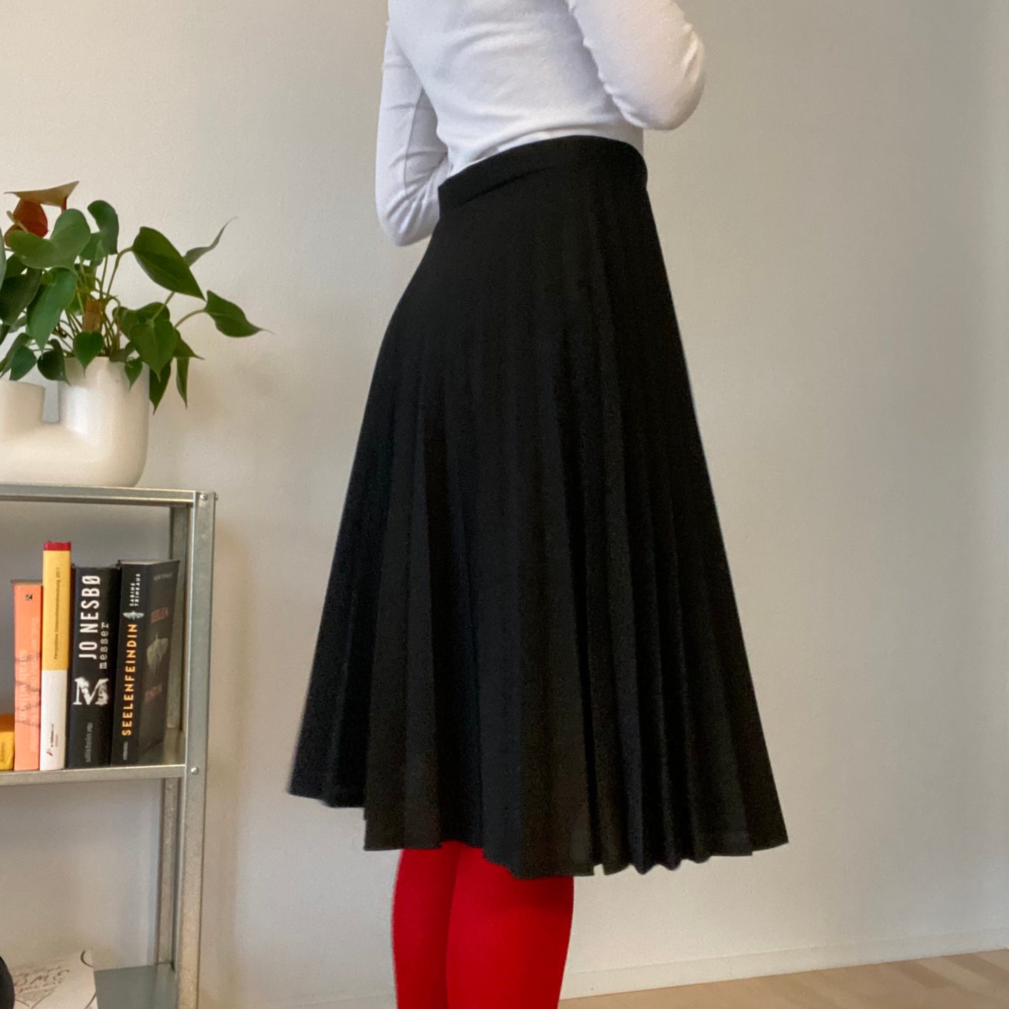 Knee length black pleaded skirt